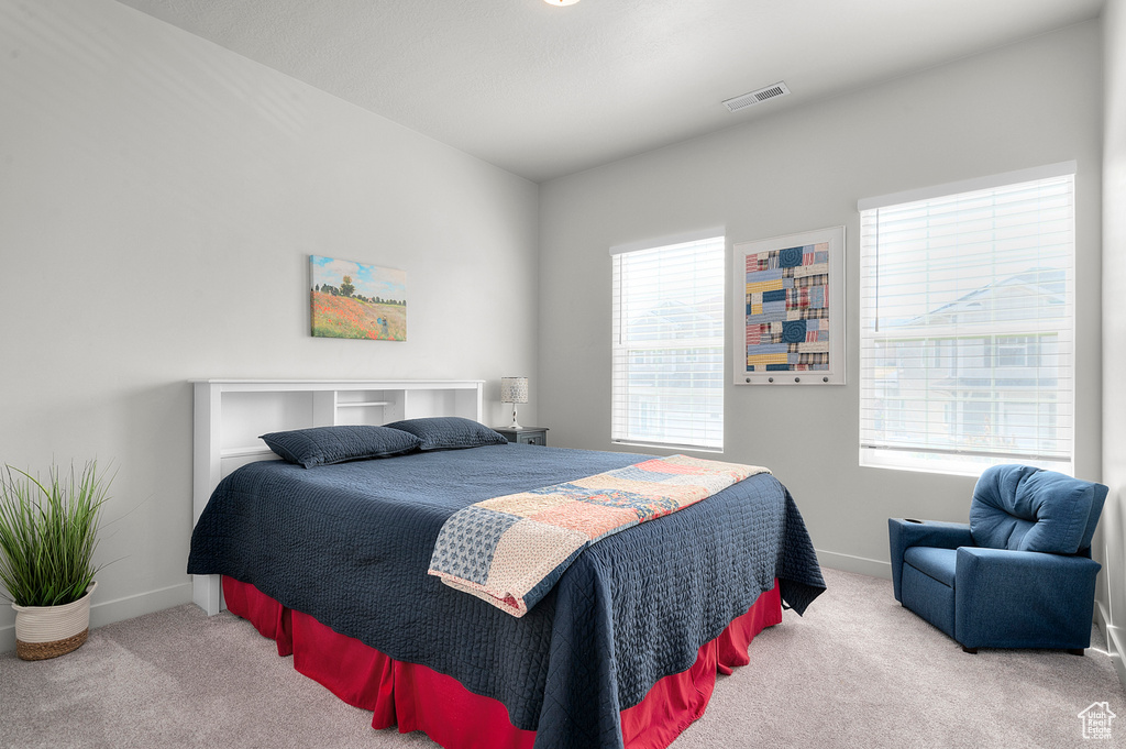 Bedroom featuring carpet floors and baseboards