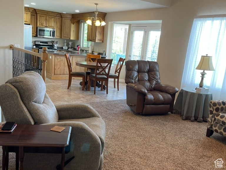 Living area featuring a chandelier, ceiling fan, and recessed lighting