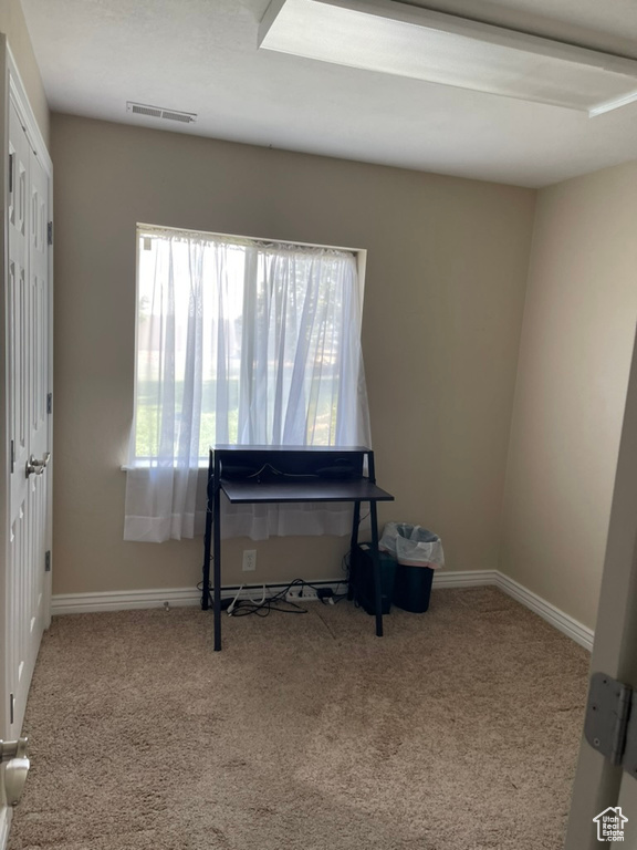 Bedroom with carpet floors and baseboards