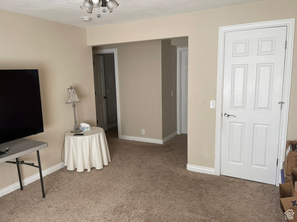 Carpeted living room with baseboards
