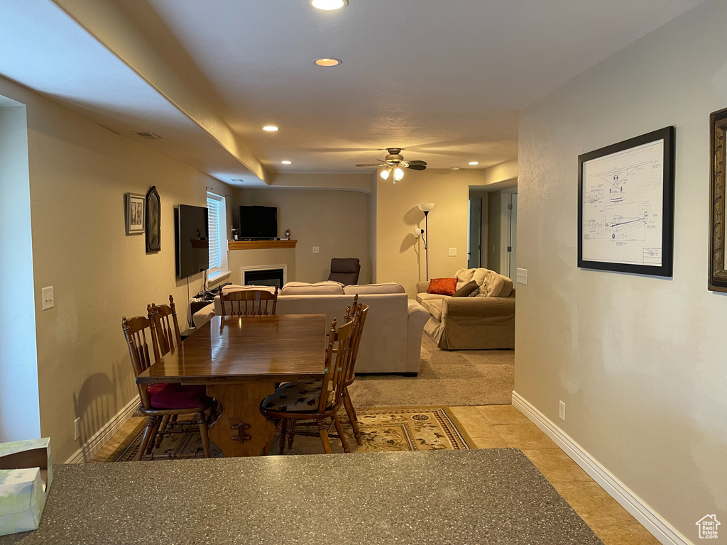 Dining space featuring a fireplace, recessed lighting, ceiling fan, and baseboards