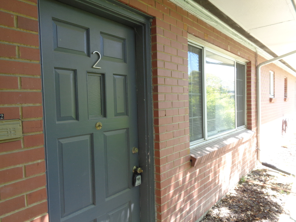 View of exterior entry with brick siding