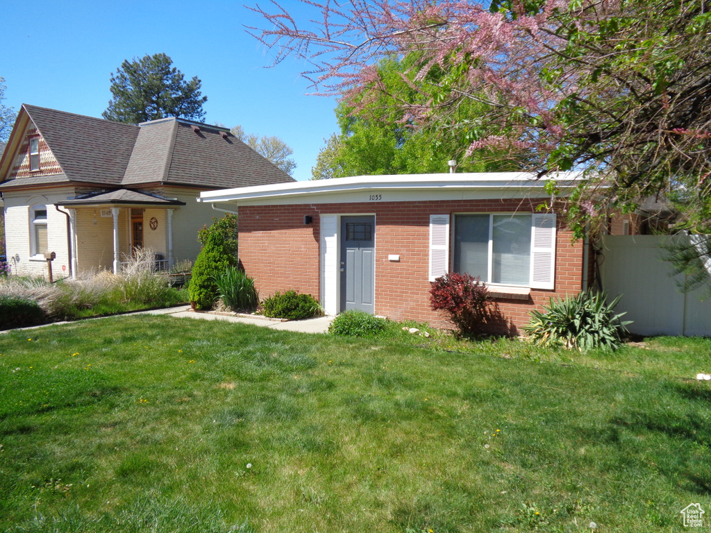 View of front of house with brick siding and roof with shingles