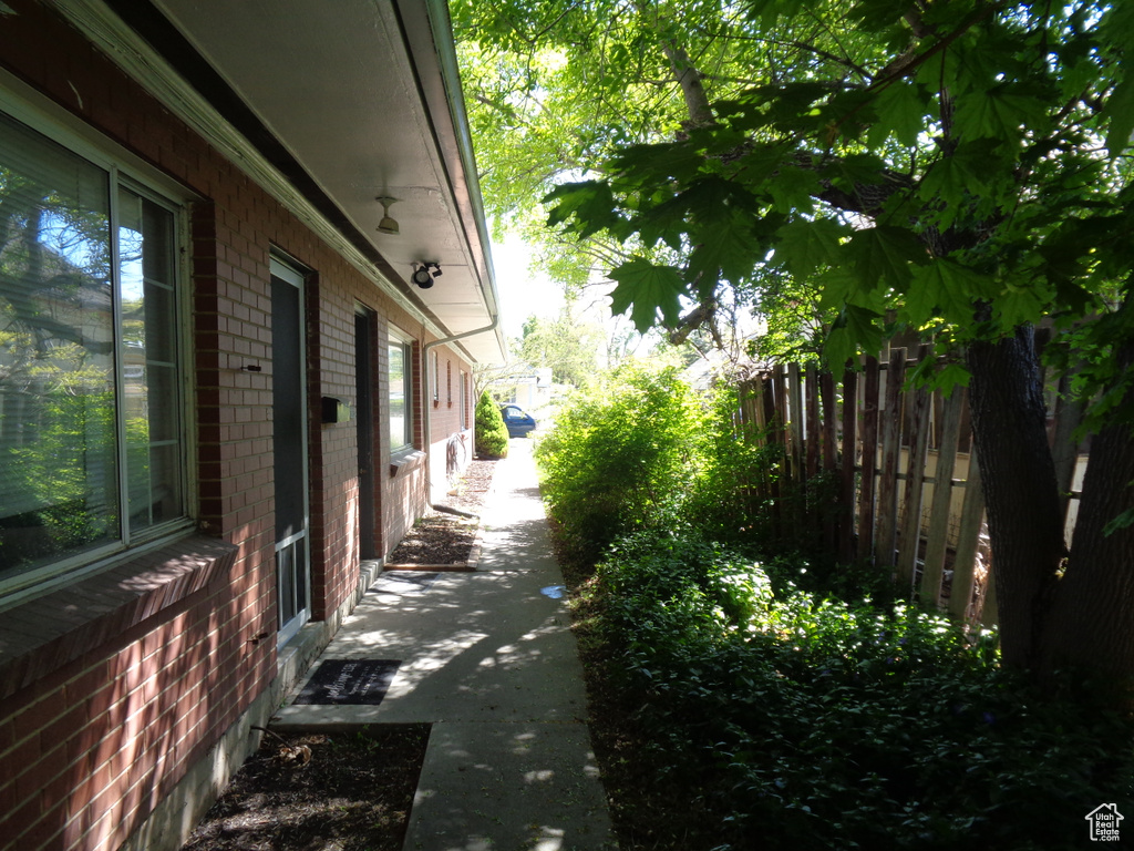 View of property exterior with fence and brick siding