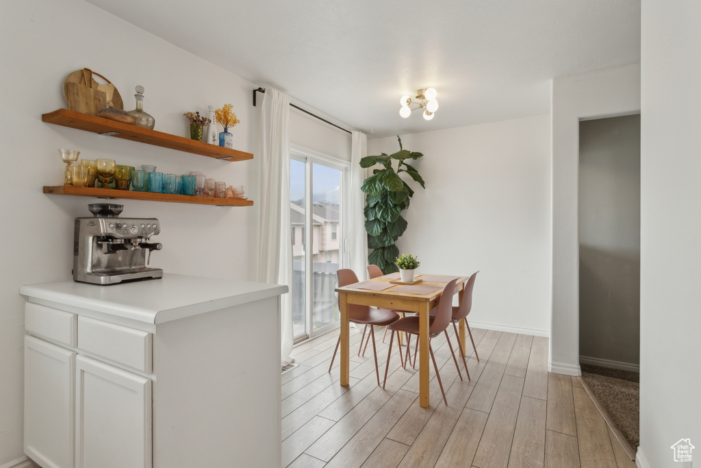 Dining space with light wood-type flooring and baseboards