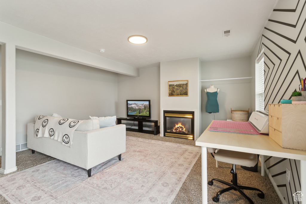 Interior space featuring a glass covered fireplace and visible vents