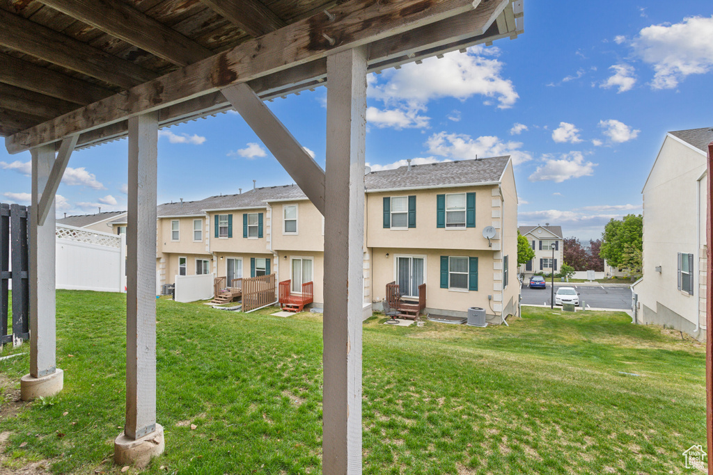 Exterior space featuring stucco siding, a residential view, and fence