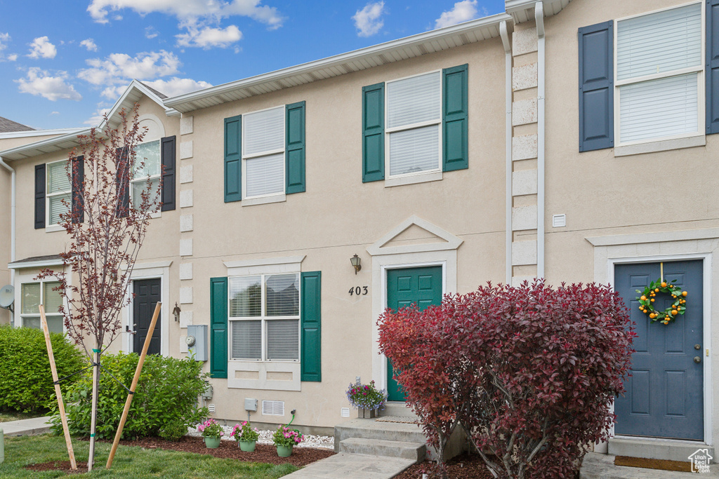 Townhome / multi-family property featuring stucco siding and entry steps