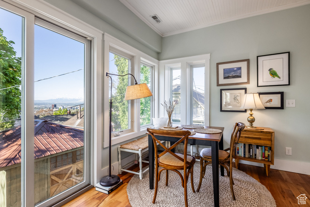 Dining area featuring crown molding, wood finished floors, and baseboards