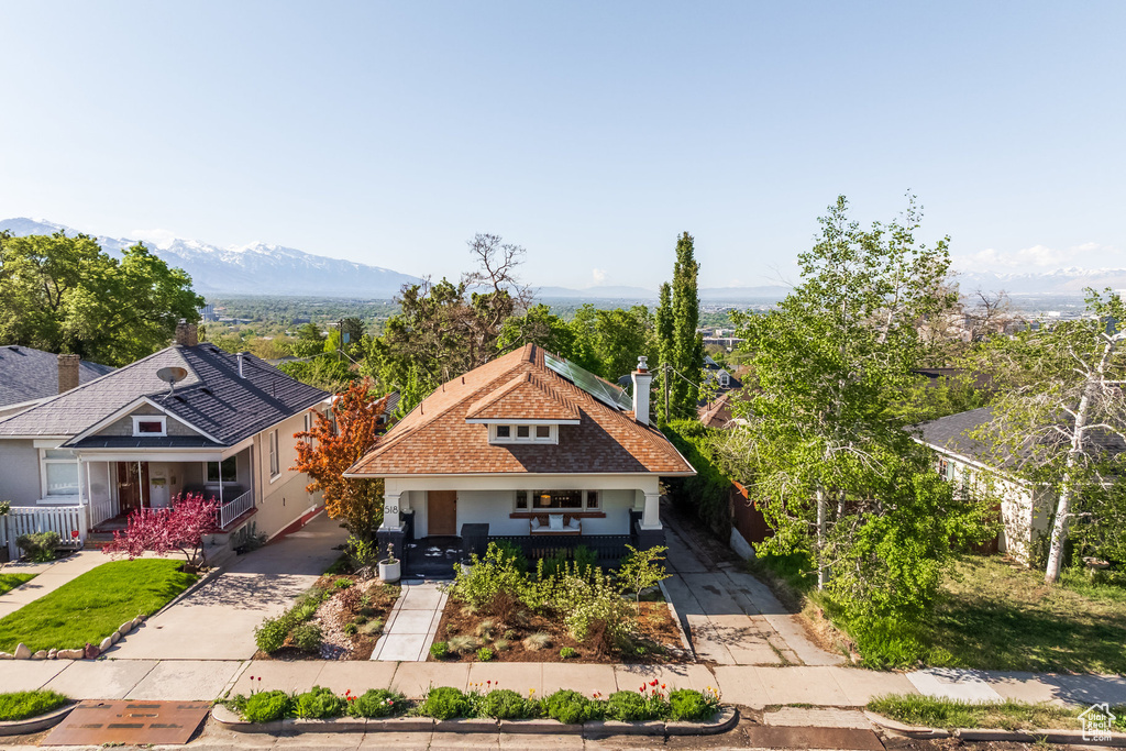 Craftsman-style house featuring a porch, concrete driveway, and a mountain view