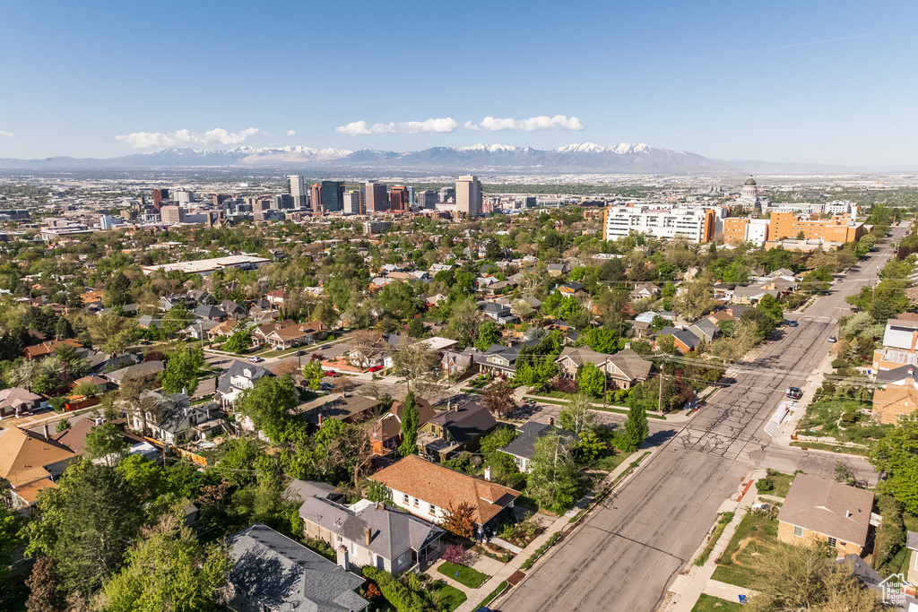 Aerial view of property and surrounding area with a mountainous background