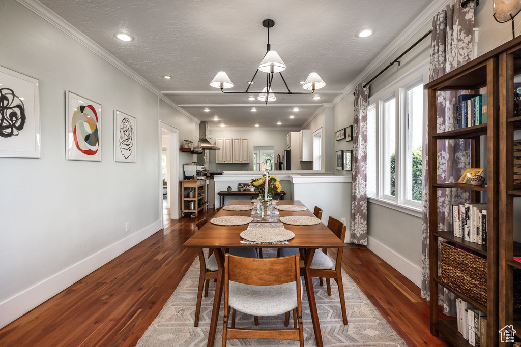 Dining area featuring ornamental molding, baseboards, dark wood finished floors, a chandelier, and recessed lighting