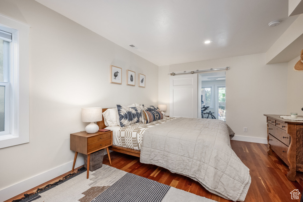 Bedroom featuring dark wood-style floors, baseboards, access to outside, and recessed lighting
