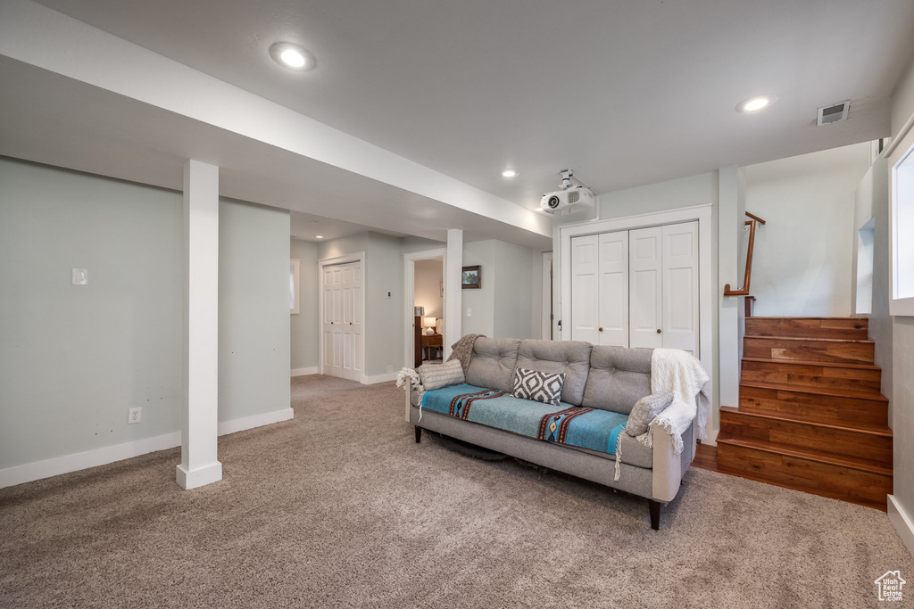 Living room featuring carpet flooring, stairs, recessed lighting, and baseboards