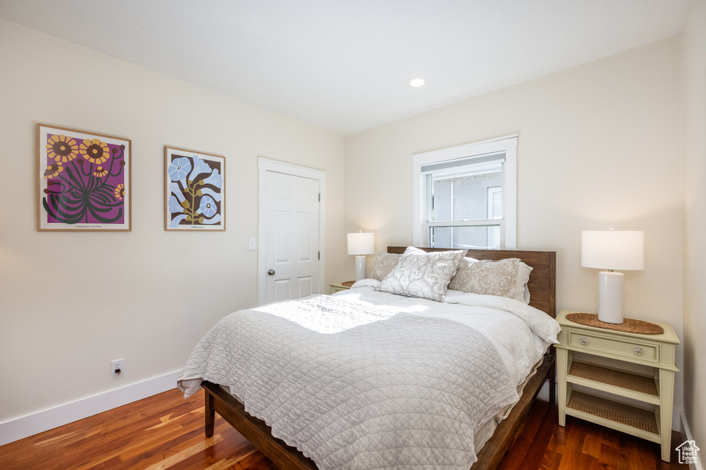 Bedroom with dark wood-style flooring, baseboards, and recessed lighting