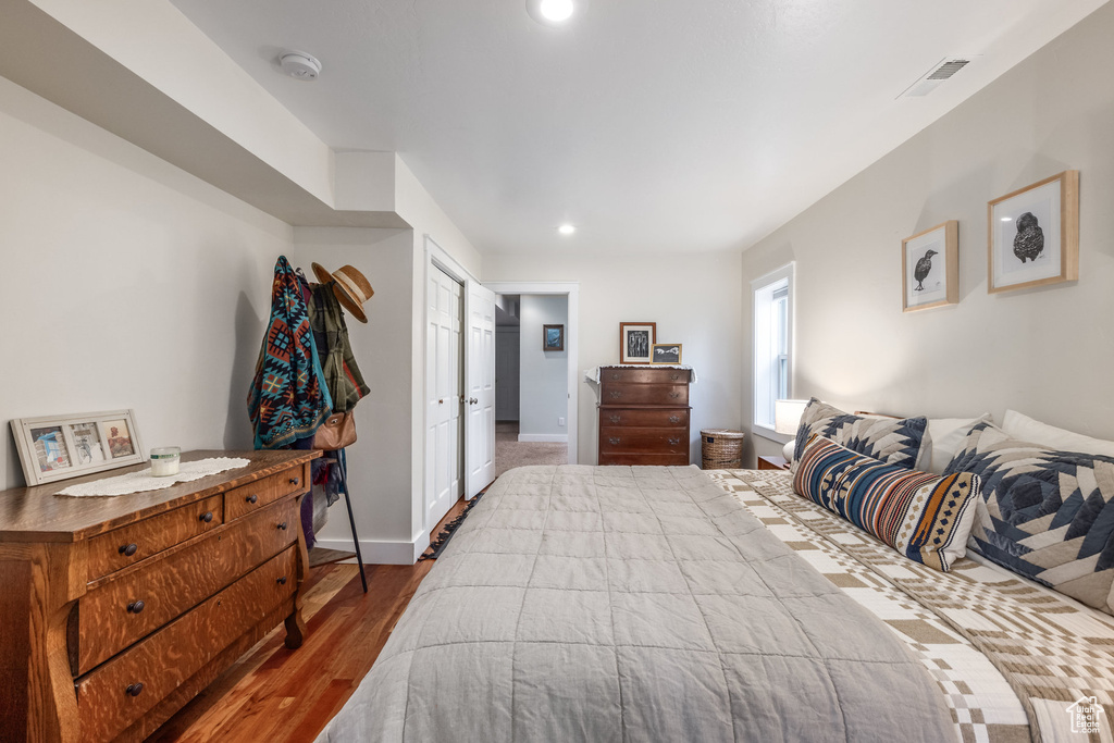 Bedroom with wood finished floors, recessed lighting, and baseboards