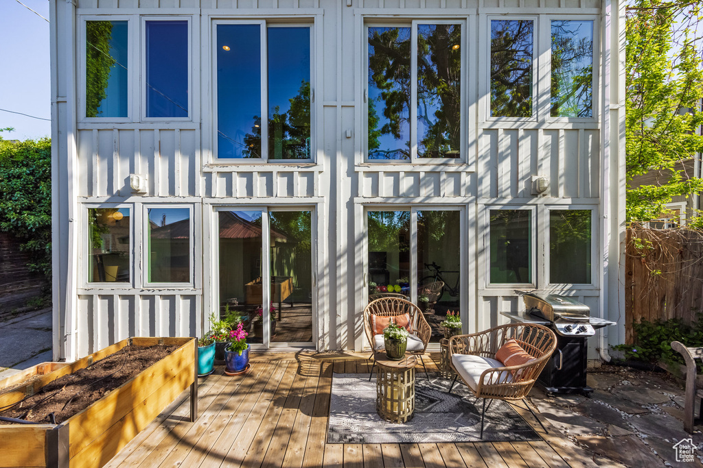 Back of house featuring board and batten siding and a wooden deck