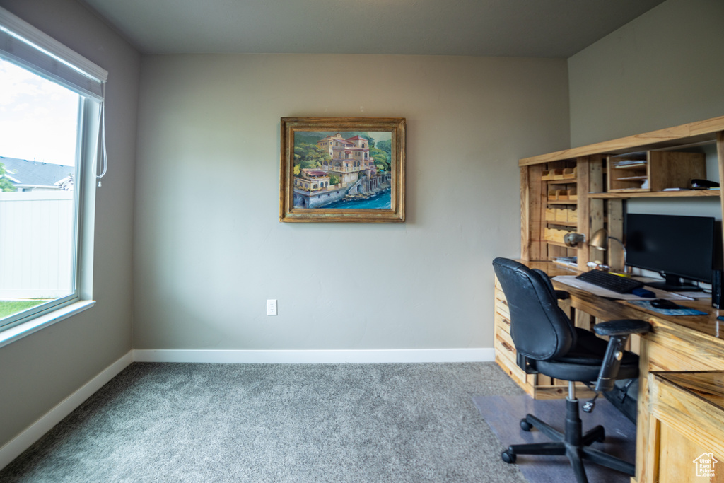 Carpeted office space featuring baseboards