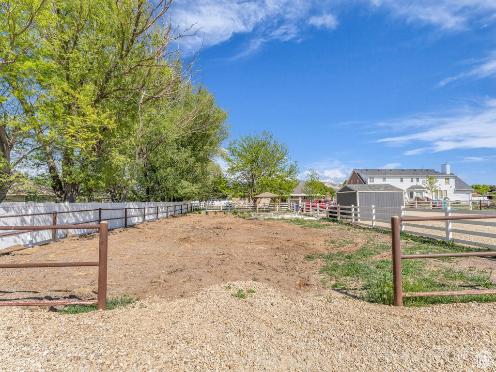 View of yard with an outdoor structure, fence, and an exterior structure