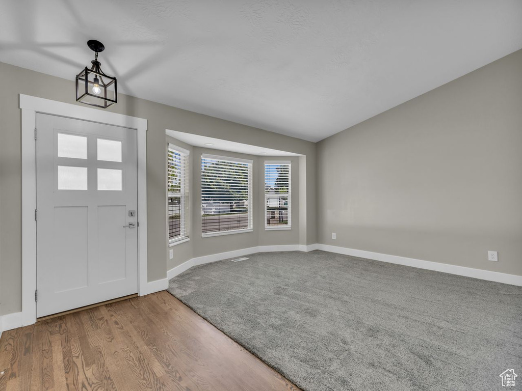 Foyer featuring wood finished floors and baseboards