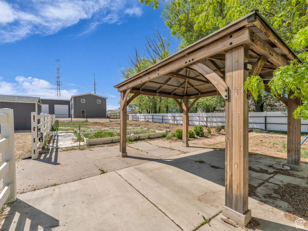 View of patio featuring fence and a gazebo