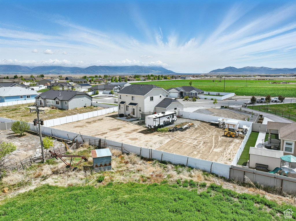 Aerial perspective of suburban area with a mountain backdrop