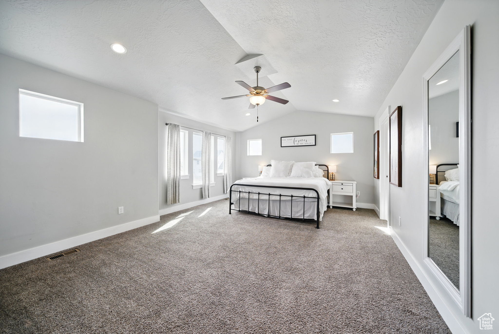 Carpeted bedroom with lofted ceiling, baseboards, a textured ceiling, ceiling fan, and recessed lighting