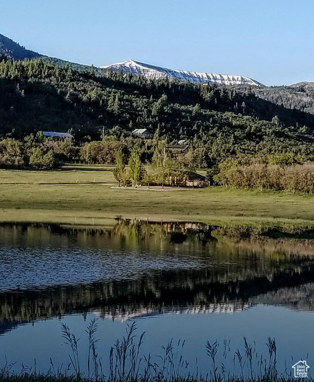 View of mountain backdrop featuring a nearby body of water