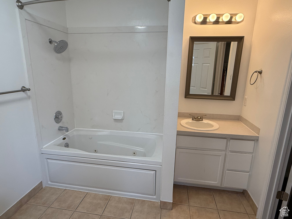 Bathroom featuring tile patterned flooring, a combined bath / shower with jetted tub, and vanity
