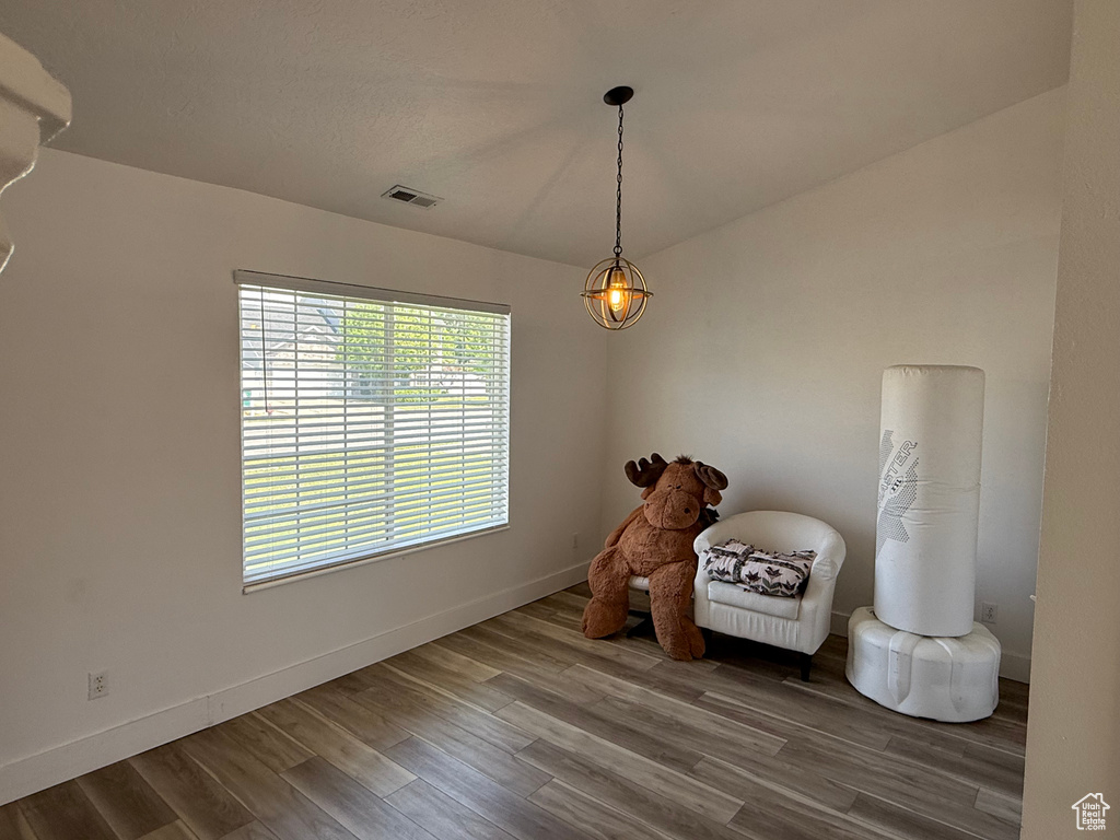 Living area with wood finished floors and baseboards