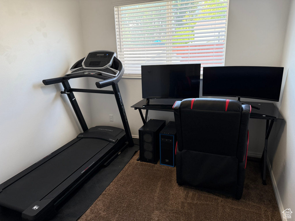Workout room with carpet floors and baseboards