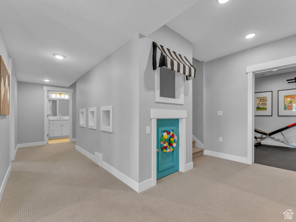 Hall with baseboards, recessed lighting, stairway, and carpet flooring