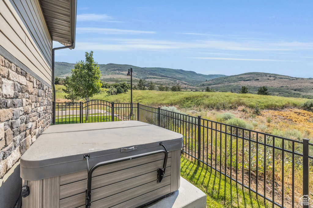 Exterior space with a mountain view and a hot tub