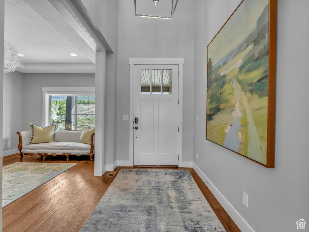 Entryway featuring baseboards and dark wood finished floors