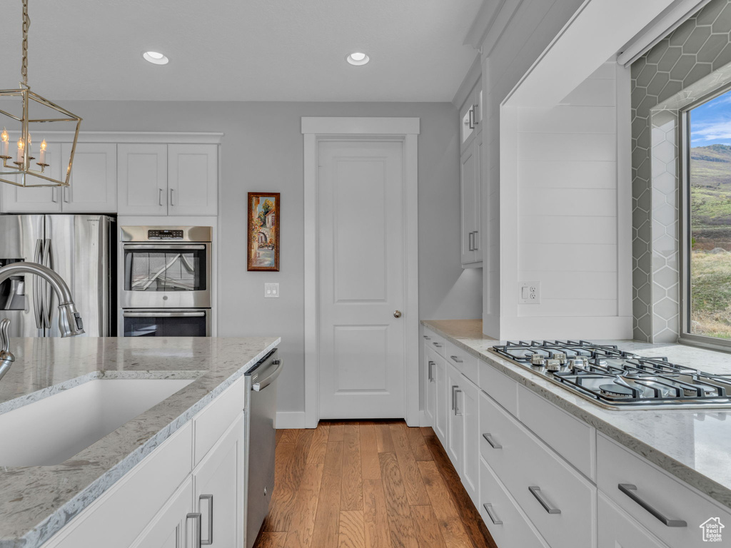 Kitchen featuring dark wood-style floors, recessed lighting, appliances with stainless steel finishes, and a sink