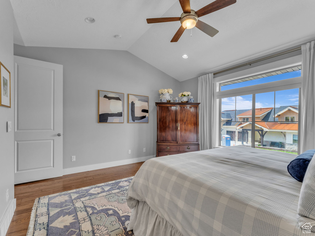 Bedroom featuring ceiling fan, baseboards, recessed lighting, vaulted ceiling, and wood finished floors
