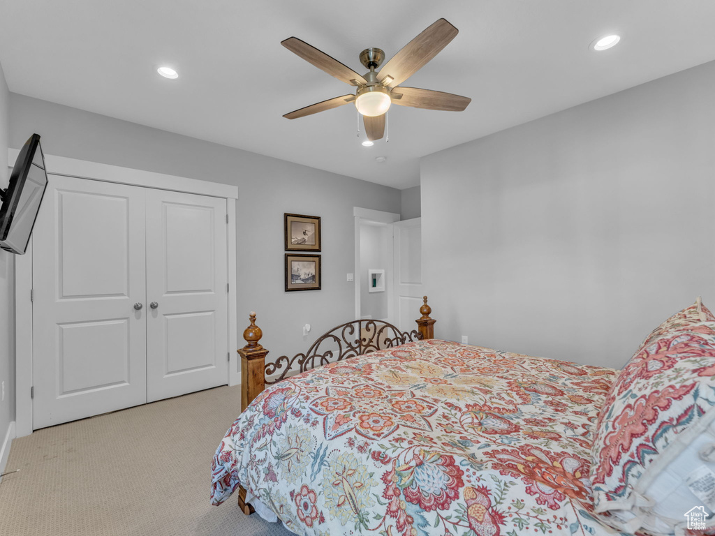 Bedroom featuring a ceiling fan, a closet, recessed lighting, and light colored carpet
