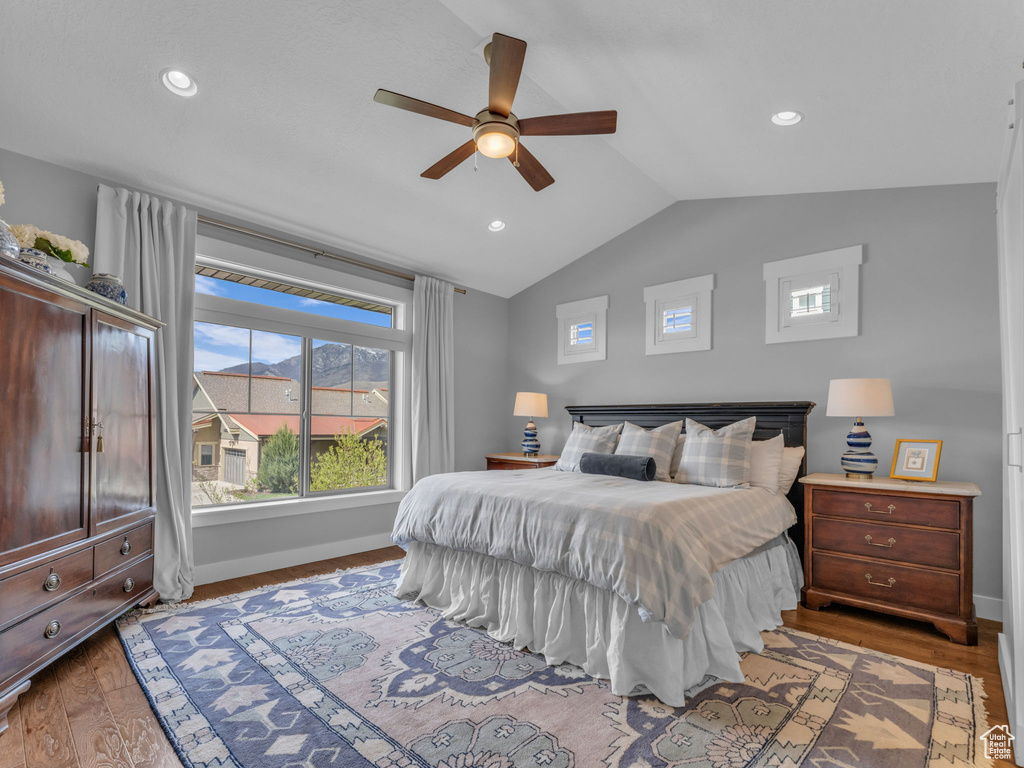 Bedroom with recessed lighting, a ceiling fan, vaulted ceiling, baseboards, and wood finished floors