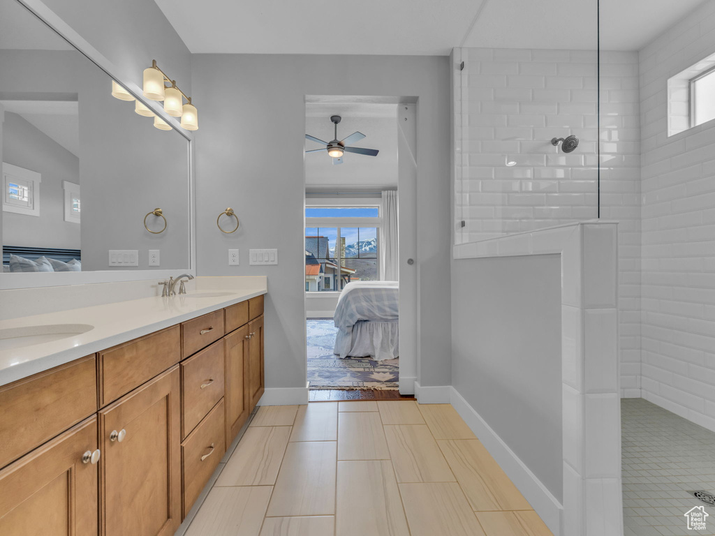 Ensuite bathroom with connected bathroom, double vanity, and a sink