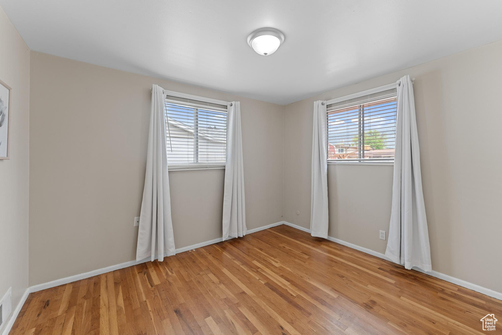 Empty room with light wood finished floors and baseboards