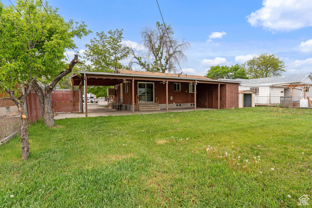 Rear view of property featuring a carport, a patio area, and entry steps
