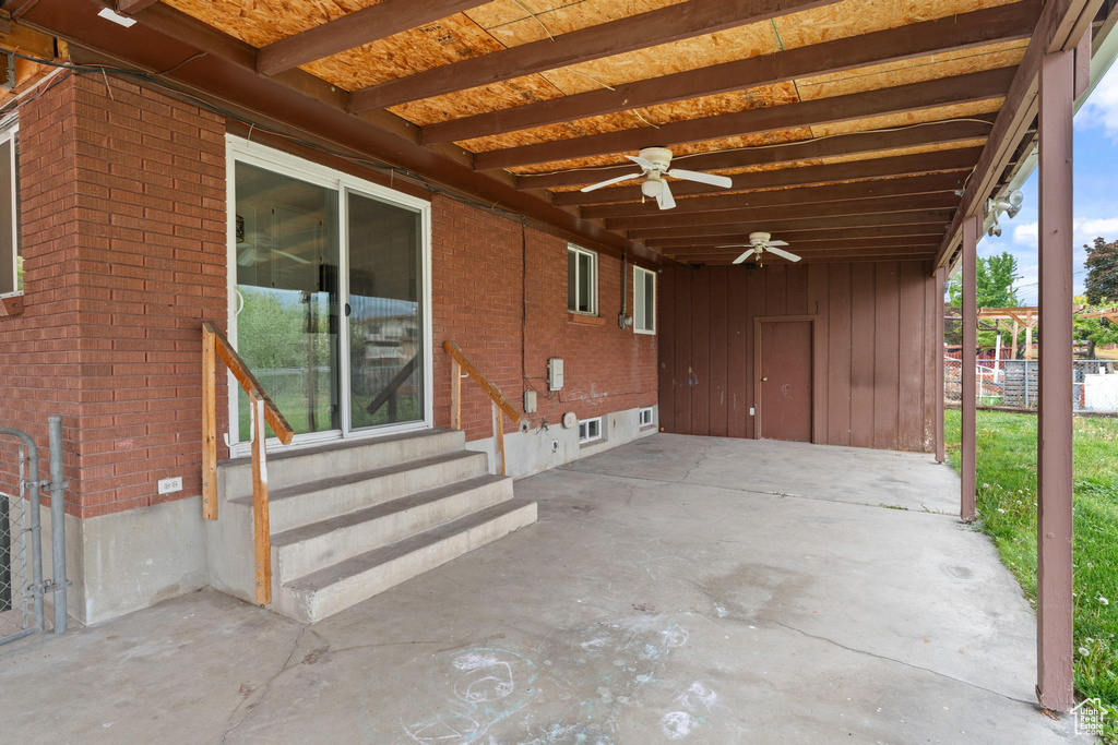 View of patio / terrace featuring entry steps, a carport, and a ceiling fan
