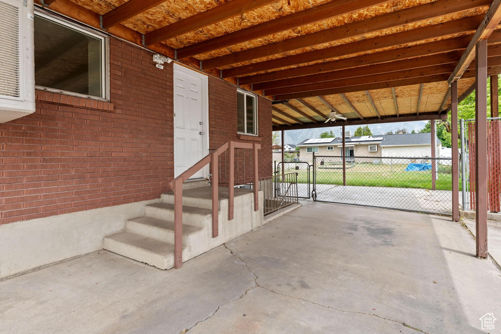 View of patio / terrace featuring fence, a gate, and a carport