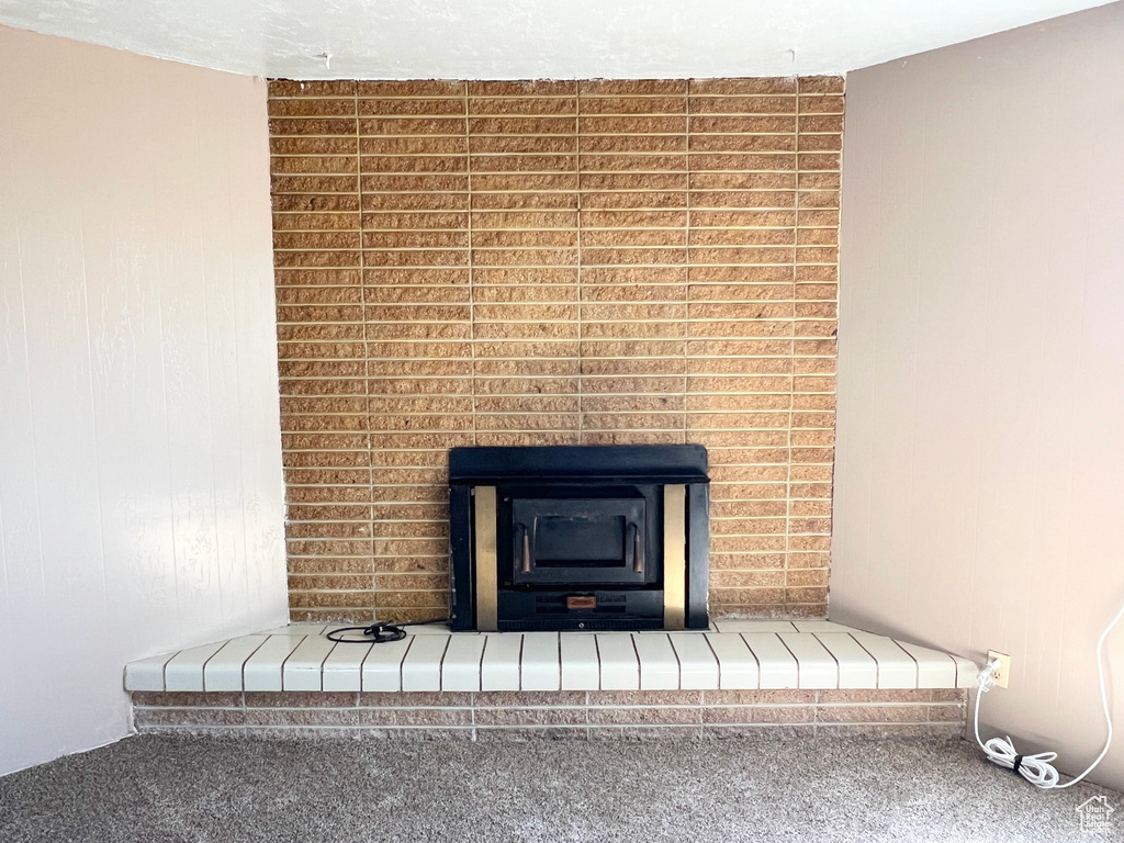 Detailed view of carpet and a fireplace