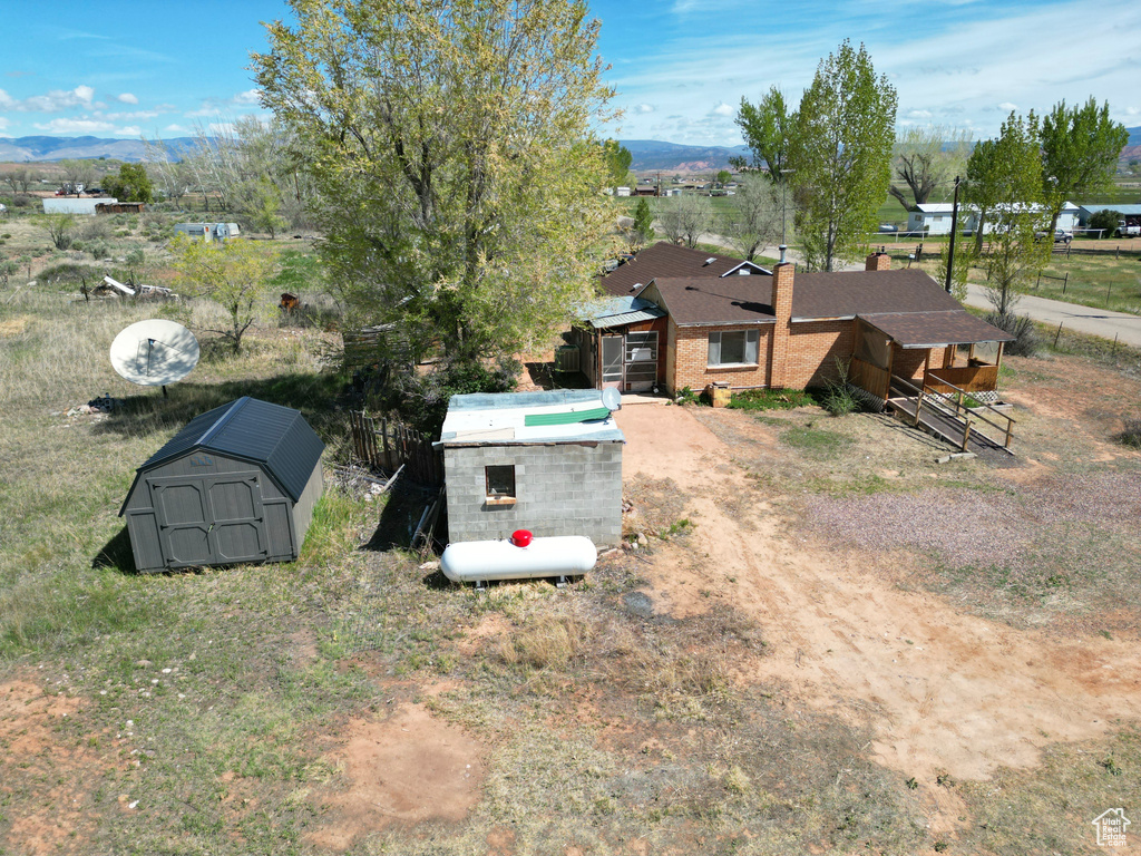 Aerial view of property and surrounding area with a mountain backdrop