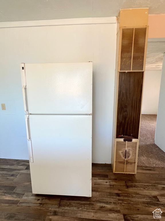 Kitchen view of freestanding refrigerator and wood finished floors