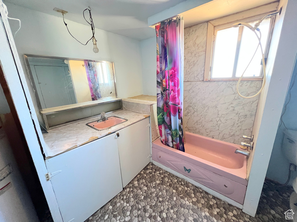 Bathroom featuring vanity and shower / tub combo
