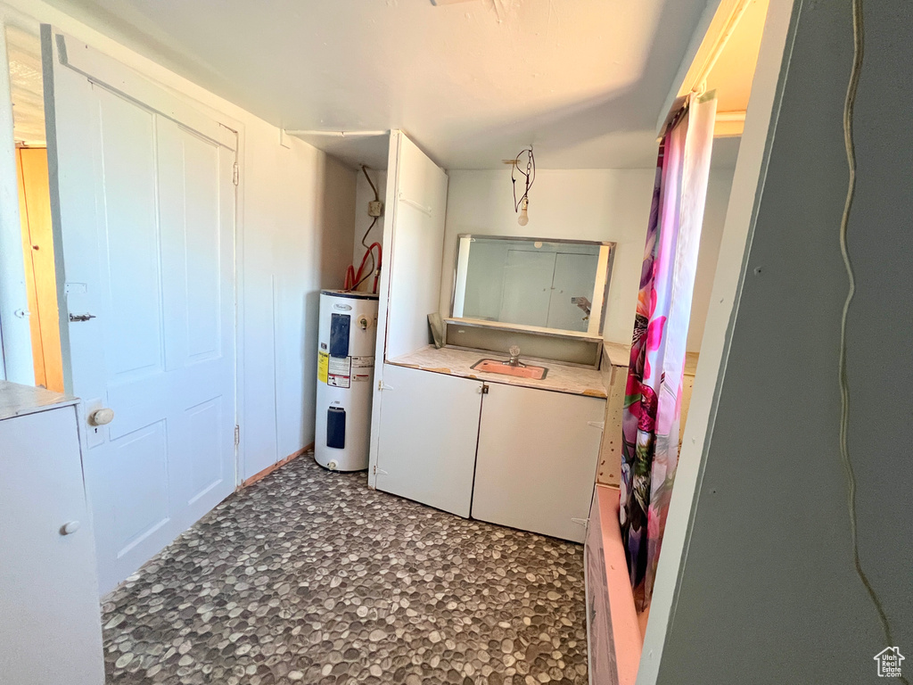 Laundry room featuring water heater