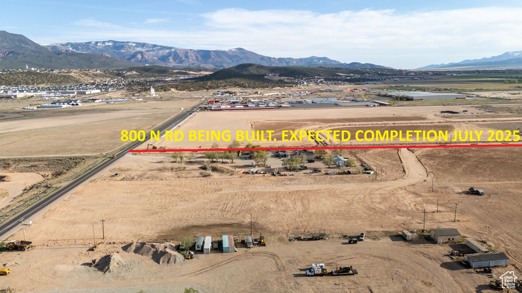 Aerial view of sparsely populated area with a mountain backdrop