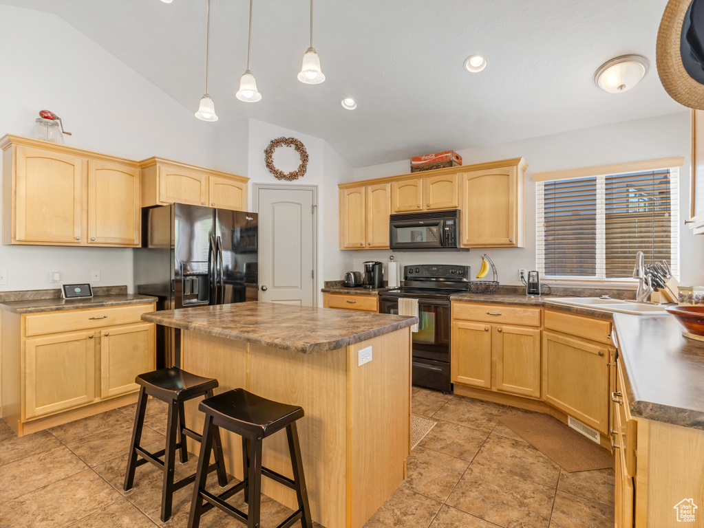 Kitchen with black appliances, light brown cabinets, a sink, and high vaulted ceiling